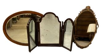 MIRRORS - a gilt framed oval wall mirror, 68cms L, a triple dressing table mirror and an oval