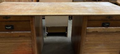 VINTAGE OAK TWIN PEDESTAL DESK with campaign type drawer handles behind tambour fronts, 80cms H,