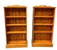 MODERN PINE OPEN BOOKCASES, a pair with adjustable shelves, 120cms H, 61cms W, 23cms D