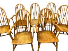 SEVEN WINDSOR STYLE ELBOW CHAIRS - light elm with spindle and hoop backs, 101cms H, 51cms W, 46cms