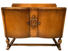 CIRCA 1930's POLISHED OAK BUFFET SIDEBOARD with railback, two cupboard doors and interior drawers,