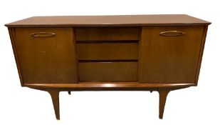 TEAK MID CENTURY SIDEBOARD with sliding doors and three central drawers, 74cms H, 128cms W, 45cms D