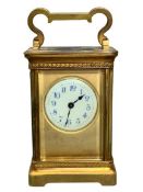 VNTAGE BRASS CASED CARRIAGE CLOCK - with key, Arabic numerals in blue to a white dial, 15cms H