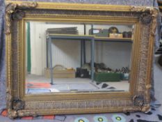 LARGE REPRODUCTION GILT FRAMED WALL MIRROR - the deep frame with shell corners and acanthus leaf