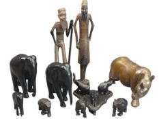 AFRICAN WOOD CARVINGS - a quantity including a rhinoceros, ebony elephants and two standing