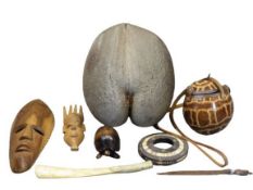 TRIBAL & ISLAND GOODS - a mixed quantity to include two carved wooden ornamental masks, metal