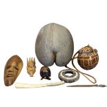 TRIBAL & ISLAND GOODS - a mixed quantity to include two carved wooden ornamental masks, metal