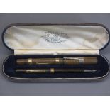 CASED WATERMAN'S IDEAL FOUNTAIN PEN & PROPELLING PENCIL SET - having 9ct gold marked collars, the