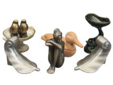 HEAVY SCROLLED METAL BOOKENDS, A PAIR, a composition figurine of a seated nude lady, a green