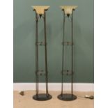 ORNATE STANDARD LAMPS - a pair, uplighters with two central glass shelves, 168cms H, 37cms diameter,