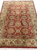 G H FFRITH LTD WOOLLEN RUG, red border with floral pattern, 192 x 122cms