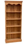 MODERN PINE BOOKCASE with five open shelves and shaped coving, 183cms H, 77cms W, 24cms D