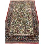 IRANIAN RUG with exotic bird and tree design having a multi-pattern border, 210 x 135cms