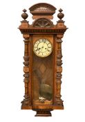 WALNUT CROSSBANDED VIENNA WALL CLOCK with painted dial having Roman numerals, eight day movement,