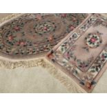 CHINESE WASHED RUGS (2) - oval, 175 x 115cms and oblong 145 x 60cms and another rug, 195 x 85cms