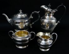 ELECTROPLATED FOUR-PIECE TEA SERVICE with reeded bands, hot water jug with ebonised handle (4)