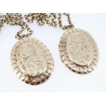 TWO SIMILAR 9CT GOLD OVAL LOCKETS, scroll engraved both with 9ct gold circle link chains, 98.7gms