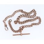 9CT GOLD ALBERT WATCH CHAIN, having graduated curb links and T-bar, 34cms long, 41.6gms