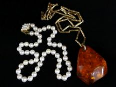AMBER PENDANT ON 9CT GOLD CHAIN, the chain weighing 11.6gms, together with string of pearls with 9ct