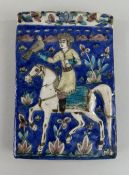 PERSIAN POTTERY TILE, Qajar style, moulded in relief with a falconer on horseback, 20 x 13.5cms