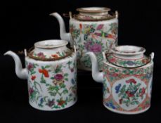 THREE CHINESE FAMILLE ROSE CYLINDRICAL TEAPOTS, largest 15cms high (3)Comments: one with starcrack