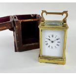 GILT BRASS CORNICHE CASE CARRIAGE CLOCK, late 19th Century, with original travelling case, the