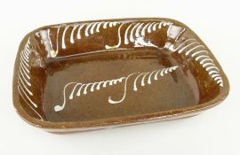 SLIPWARE POTTERY BAKING DISH, possibly Sunderland, rectangular with repeated tapering S-motif,