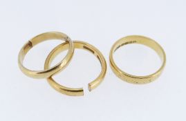 THREE GOLD RINGS comprising two 22ct gold wedding bands (7.4gms) and an 18ct gold wedding band (2.