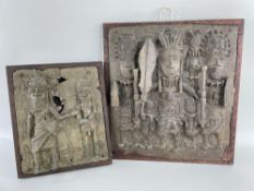 TWO NIGERIAN BENIN-STYLE BRASS PLAQUES, featuring oba, attendants and soldiers, in hardwood wood
