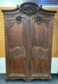 19TH CENTURY PROVINCIAL FRENCH OAK ARMOIRE, probably Normandy, carved C-scroll cornice with high