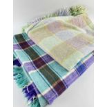 TWO TRADITIONAL WOOLLEN BLANKETS, one purple, brown and green plaid, 168 x 420cms (small tear),