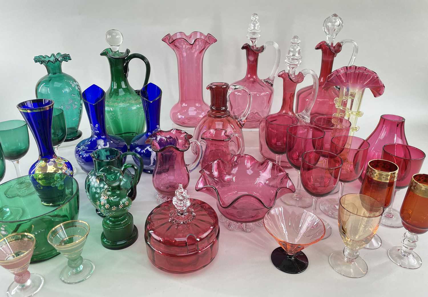 ASSORTED VICTORIAN COLOURED GLASSWARE, including three cranberry decanter jugs and stoppers, pair
