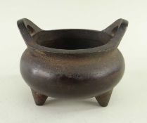 CHINESE BRONZE TRIPOD CENSER, with twin handles and 4-character Xuande mark to base, 9cms high x