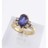 18K GOLD TANZANITE & DIAMOND RING, the central pear shaped tanzanite flanked by three diamonds