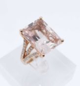18K GOLD DRESS RING, set with large pink semi-precious central stone with diamond chip shoulders,