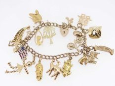 9CT GOLD DOUBLE LINK CHARM BRACELET, with heart shaped padlock, an assortment of yellow metal charms