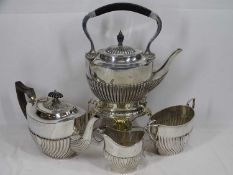 NEAR MATCHED FOUR PIECE EPNS TEA SERVICE to include a good spirit kettle on stand, 35cms H overall