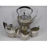 NEAR MATCHED FOUR PIECE EPNS TEA SERVICE to include a good spirit kettle on stand, 35cms H overall