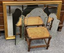 GILT FRAMED WALL MIRROR, bevelled edge triple dressing table mirror and an oak footstool with cane