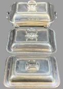 TWO LIDDED ENTREE DISHES and a four footed Sheffield type twin-handled food warmer, 8 x 34 x 20cms