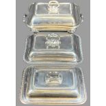 TWO LIDDED ENTREE DISHES and a four footed Sheffield type twin-handled food warmer, 8 x 34 x 20cms