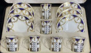 AYNSLEY SILVER/CHINA COFFEE SET - 6 cased deep blue and gilt bordered coffee cups and saucers, the