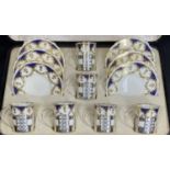 AYNSLEY SILVER/CHINA COFFEE SET - 6 cased deep blue and gilt bordered coffee cups and saucers, the