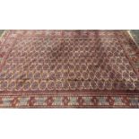 HANDMADE PERSIAN CARPET - ground red with a multi border and central diamond pattern, with