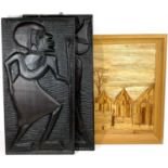 CARVED AFRICAN EBONISED PANELS and a straw work picture of an African type village, 63 x 32cms the