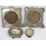 THREE SHAPED HALLMARKED SILVER PHOTOGRAPH FRAMES and a small oval unmarked white metal example,