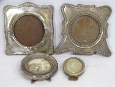 THREE SHAPED HALLMARKED SILVER PHOTOGRAPH FRAMES and a small oval unmarked white metal example,