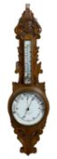 CARVED OAK CIRCULAR DIAL ANEROID WALL BAROMETER - in fine colour and condition and with mercury