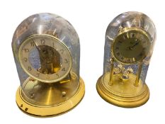 GLASS DOMED & BRASS EFFECT MANTEL CLOCKS - to include a Hermle Quartz Anniversary clock, 23cms H and