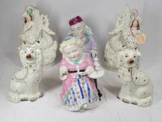 VICTORIAN TOBACCO JARS, a pair, modelled as a seated elderly lady and gentleman, 22cms high with